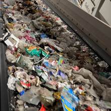 Mixed household plastic packaging on the sorting line