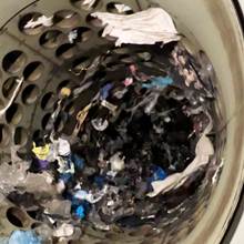 A rotating drum mechanically performs the initial coarse sorting, separating the plastic by size through perforations of different diameters.